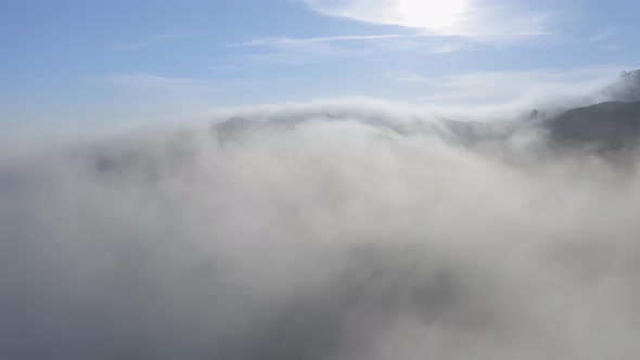  Cinematic Nature. Drone View Flying Through Thick White Fog Clouds at Sunrise alt