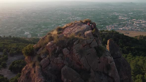 Climbing mountain in Spain. Drone aerial view of climber woman and man that climb a big rock. alt