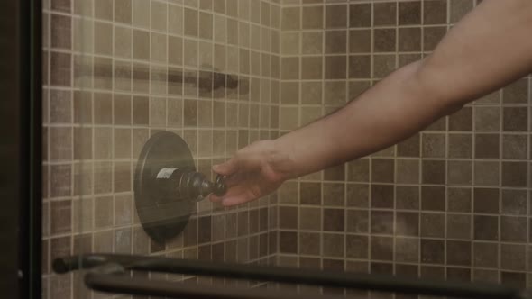 Blured Man Hand Includes Shower Handle Behind Blurry Glass alt