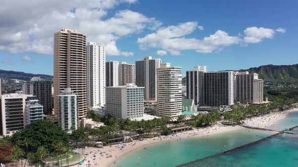 Aerial rising and panning wide shot of picturesque Waikiki Beach on the island of O'ahu, Hawaii. 4K alt
