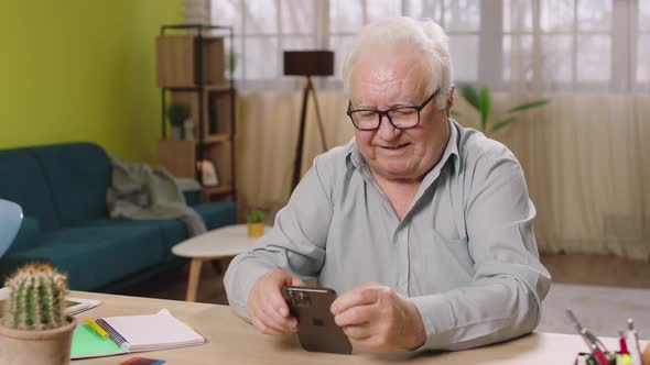 Capturing Video of Old Man Sitting on His Working alt