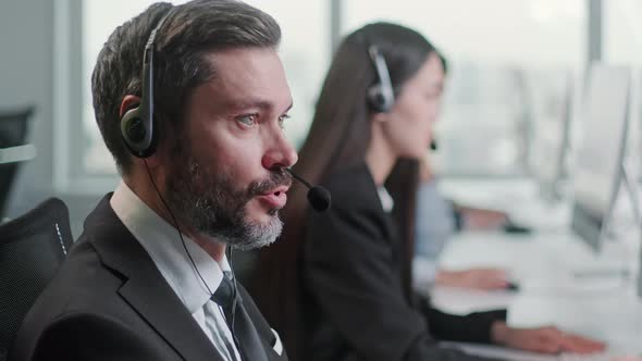 Close Up Portrait Man of a Technical Customer Support Specialist Talking on a Headset While Working alt