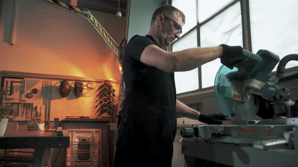 Engineer in a factory working on a angular grinding machine.