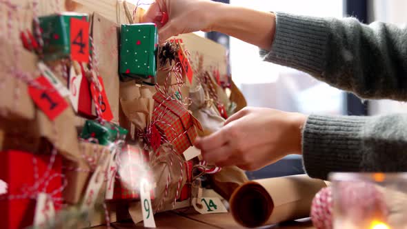Hands Making Christmas Advent Calendar at Home alt