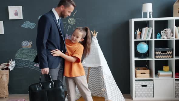 Caring Child Asking Dad to Stay Home Holding Hand Hugging Then Feeling Sad When Father Leaving alt