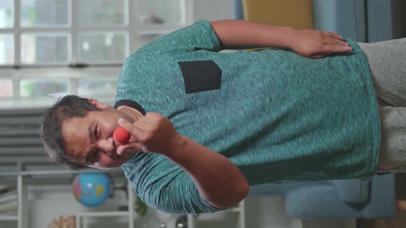 Asian Man Blogger Shoots Video Content For Social Networks, Magician With Red Ball alt