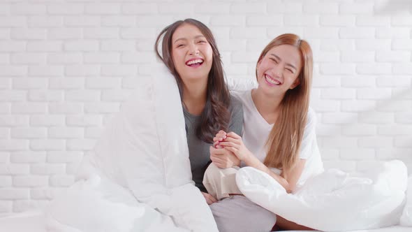 Beautiful two female LGBT lesbian embracing together in blanket cover body with love and romance on alt