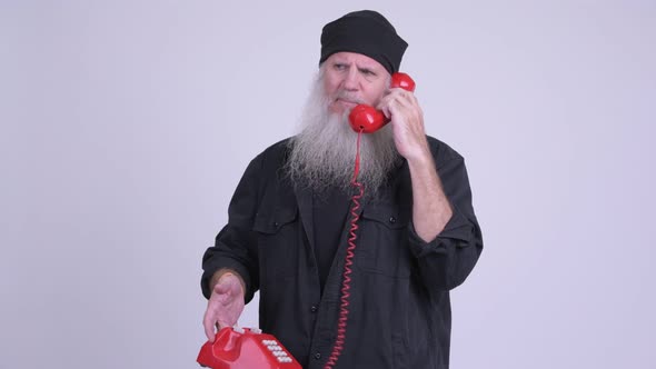 Angry Mature Bearded Hipster Man Talking on the Phone alt