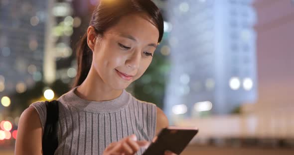 Woman using cellphone in the street at outdoor  alt