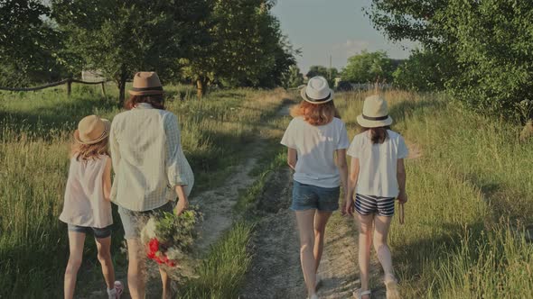 Mother Walking with Her Daughters, Woman Holding the Hand of Child alt