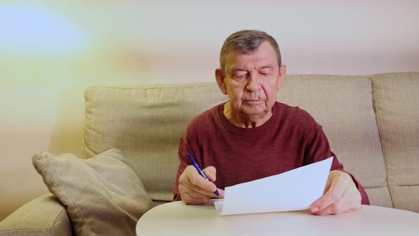 Elderly Man Signs Business Documents