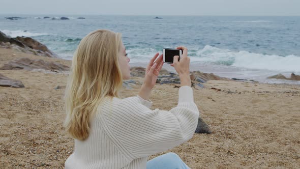 Woman Inspired By Ocean Is Taking Pictures on Mobile Phone