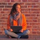 Beautiful Woman with Laptop Sitting on Floor Near Brick Wall - VideoHive Item for Sale