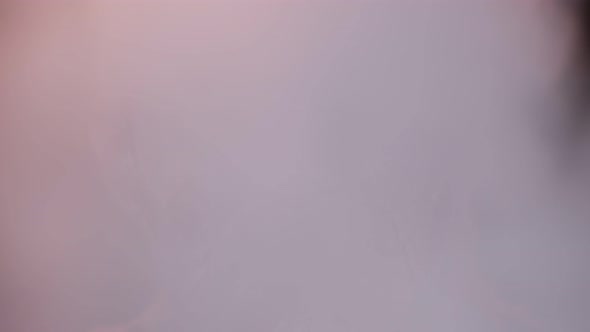 Zombie Man with Makeup with Wounds Scars and White Contact Lenses Blows Smoke From Mouth Smiling alt