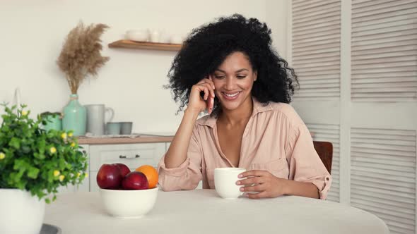 Cute African American Woman Talking on Her Mobile Phone and Smiling Happy alt
