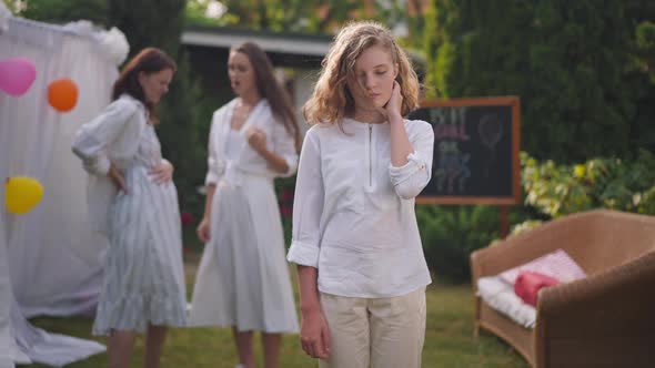 Medium Shot Portrait of Worried Teenage Girl Standing Outdoors Thinking As Pregnant Woman Talking alt