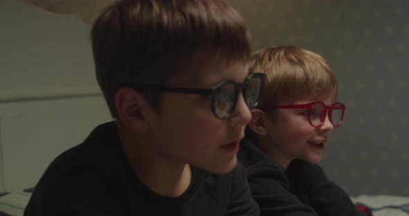 Two Brothers in Eyeglasses Watching Evening Movie Before Bedtime alt