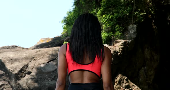 Summer vacation black woman having fun on beach walking relaxing in the sun wearing bikini. alt