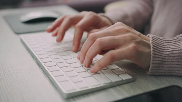 Female Hands Typing on Modern Keyboard alt
