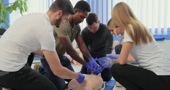 Closeup of Students Practicing CPR Chest Compression on Dummy alt