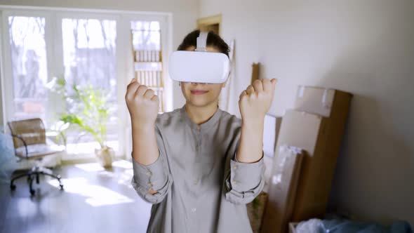 Woman in White VR Headset in New Rent Flat