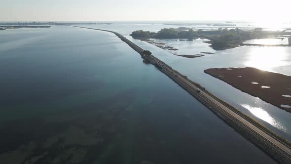 Aerial view of vehicles driving on a beautiful road, Italy. alt