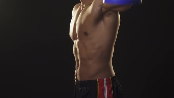 Muscular Handsome Shirtless Athletic Man Exercising with Weights