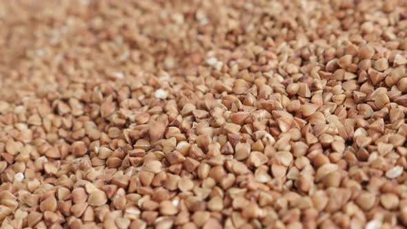 Slow motion fall of buckwheat seed over the pile close-up FullHD footage