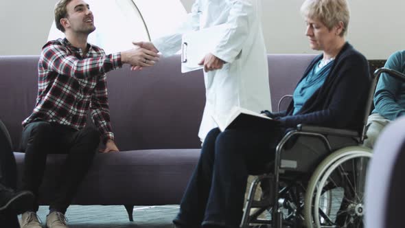 Doctor consulting patient in hospital waiting room