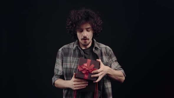 The Young Hipster is Amazed By the Content of the Gift