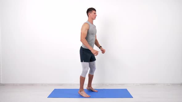 Muscular Man Doing Squats Exercise on Fitness Mat White Background Sport alt