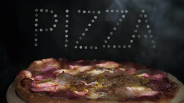 Delicious Fresh Italian Pizza On A Black Background With The Effect  Of Light Inscription Pizza