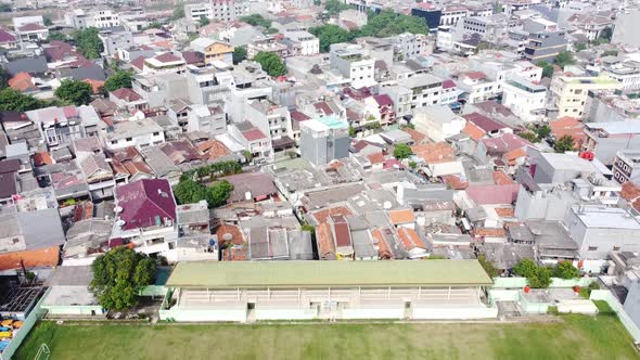 Aerial view of residential areas, near soccer fields during the day alt