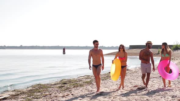Beautiful Guys and Girls Go on the Wild Beach. alt