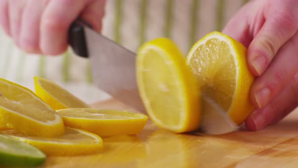 Slicing fresh lemons, closeup alt