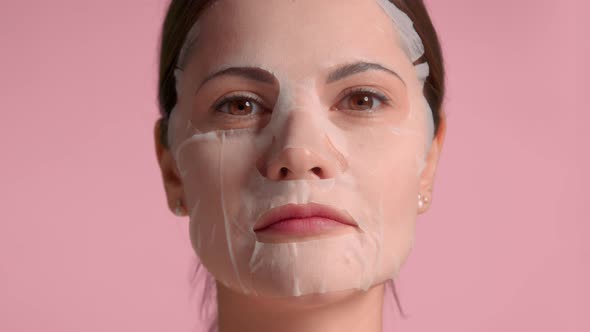 30s Brunette Woman Wears with Sheet Mask on Face