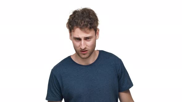 Portrait of Impudent Guy in Tshirt Being Aggressive and Swearing with Irritation Isolated Over White alt