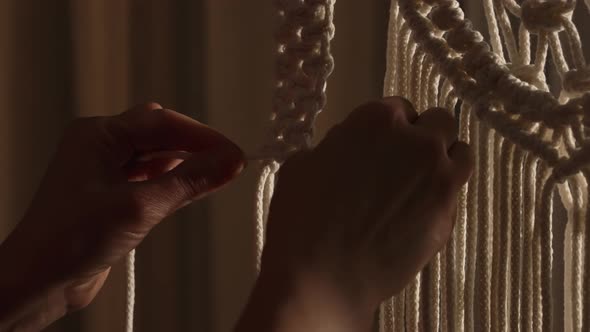 Woman Weaves Pattern of Macrame Threads with Her Own Hands for Decoration or Home Decor alt