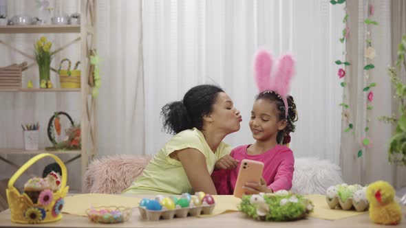 Mom and Daughter with Funny Bunny Ears Take Selfies and Have Fun alt
