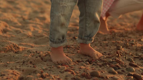 Legs of a Small Child Closeup on the Sea Shore