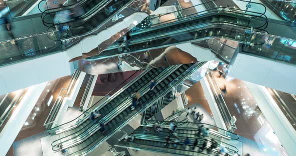 Time Lapse Escalators in Modern Shopping Mall Crowd of People.  alt