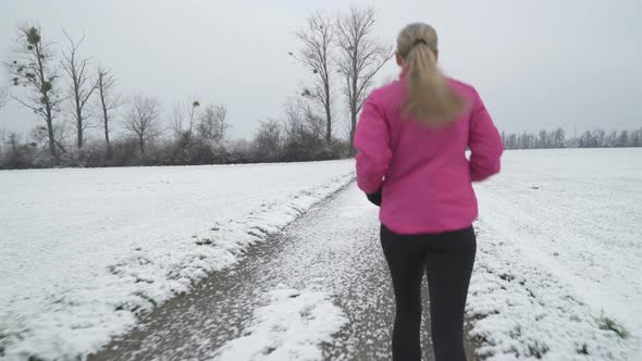 Medium Shot Back View Woman Running in Winter