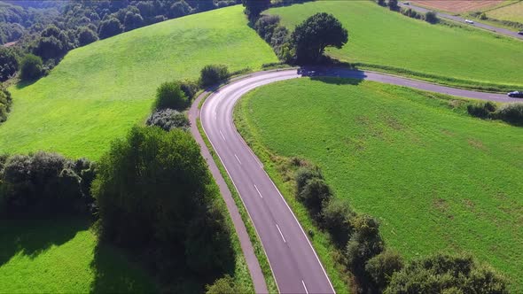 A curved road somewhere on a german country side alt