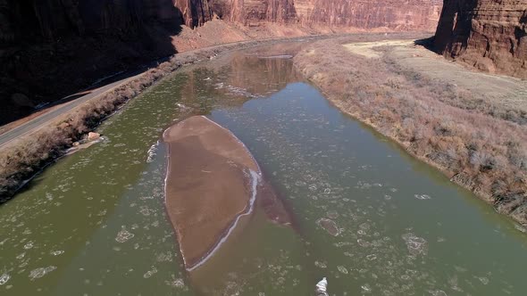 Aerial view flying over Colorado River through canyon in Moab alt