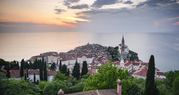 Timelapse of Slovenia at Piran old town with Mediterranean Sea and traditional red rooftops. Elevate alt