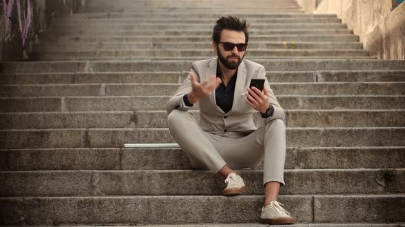 Man Freelance With Smartphone Outdoors. Businessman With Phone On Stairs. Freelancer Internet Online alt