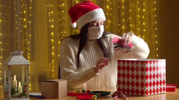 Woman Mask Packing Presents Colorful Christmas Box