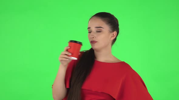Portrait of Pretty Young Woman Is Enjoying Coffee. Green Screen alt