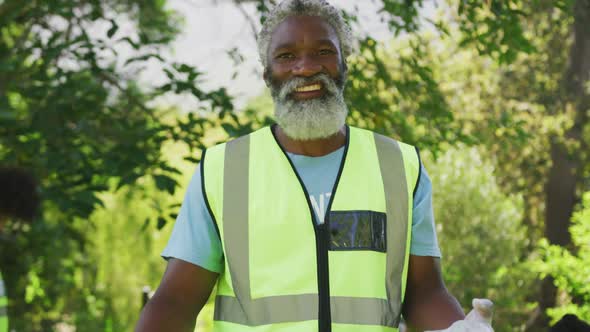 Happy family cleaning a garden together alt