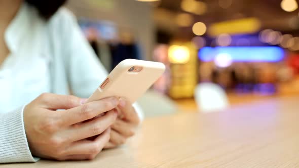Woman using mobile phone at indoor alt
